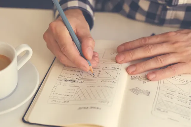Writing project notes in a notebook